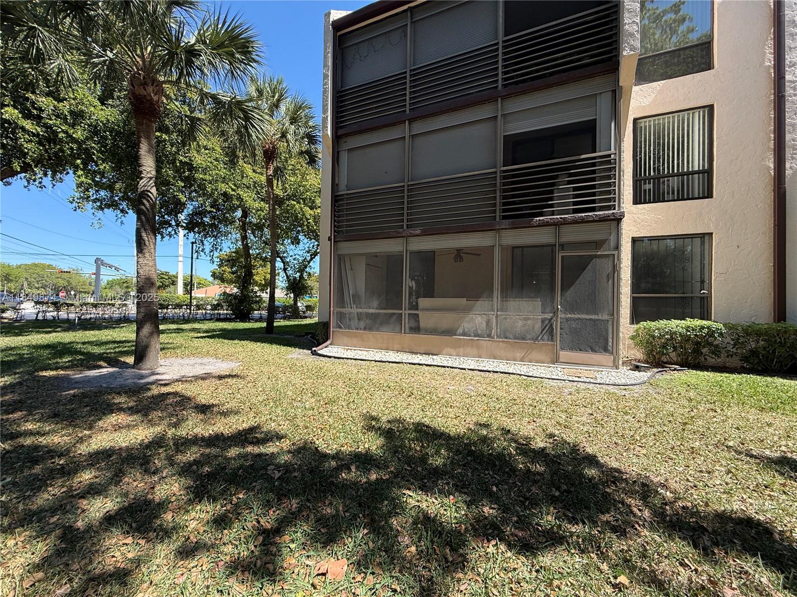 7950 West McNab Road, Unit 102 Tamarac, FL 33321 - Photo 26 of 34 a view of a house with a yard