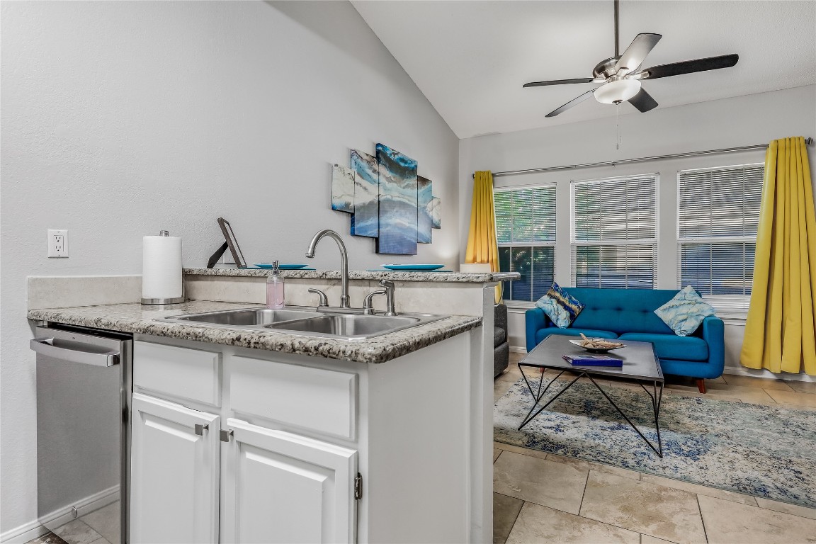3404 American Drive, Unit 3300 Lago Vista, TX 78645 - Photo 37 of 39 a living room with granite countertop furniture a rug and a chandelier