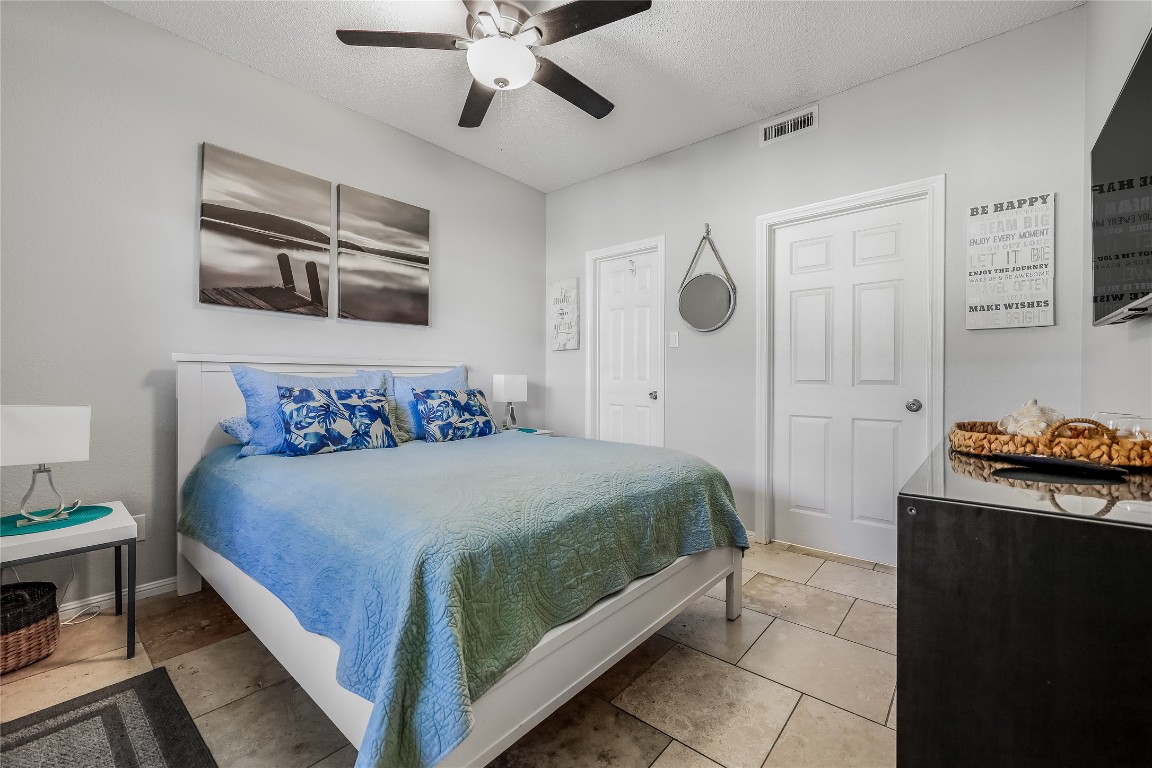 3404 American Drive, Unit 3300 Lago Vista, TX 78645 - Photo 8 of 39 a bedroom with a bed and a chandelier