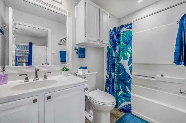 a bathroom with a sink a toilet and bathtub
