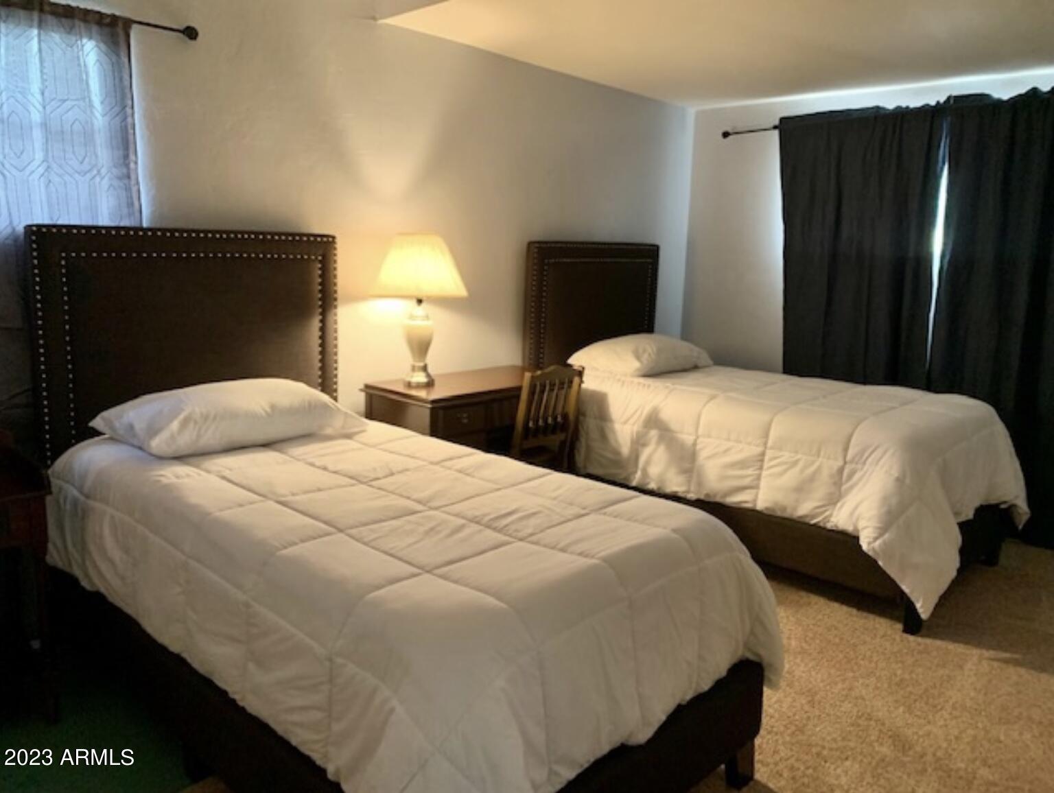 877 East Sycamore Street, Unit A Globe, AZ 85501 - Photo 4 of 8 a bedroom with two beds and a closet