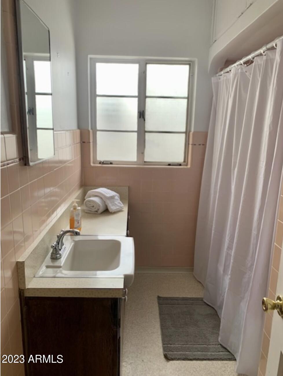 877 East Sycamore Street, Unit A Globe, AZ 85501 - Photo 6 of 8 a bathroom with a sink a window and a shower