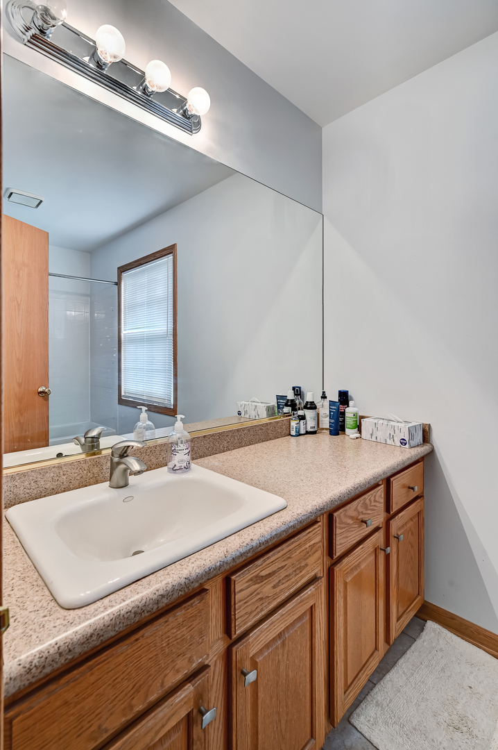 1934 Manning Road Darien, IL 60561 - Photo 15 of 18 a bathroom with a sink and a mirror
