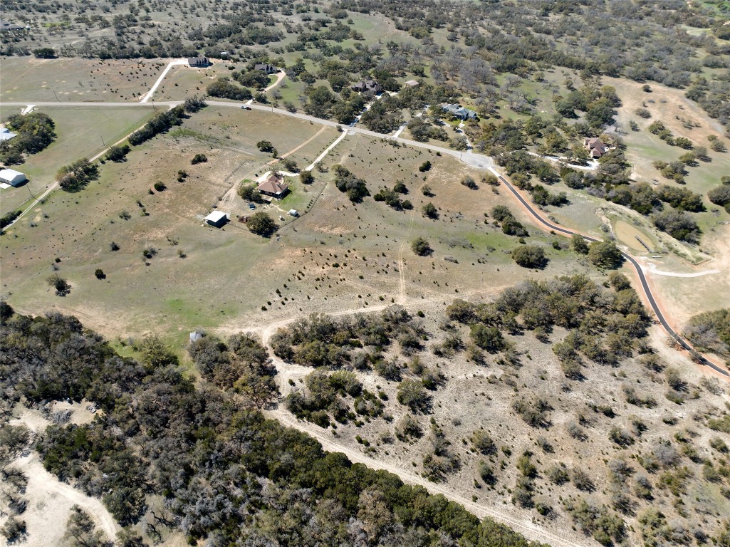 1440 Stone Ridge Mountain Drive Round Mountain, TX 78663 - Photo 11 of 23 a view of a dry yard with wooden fence
