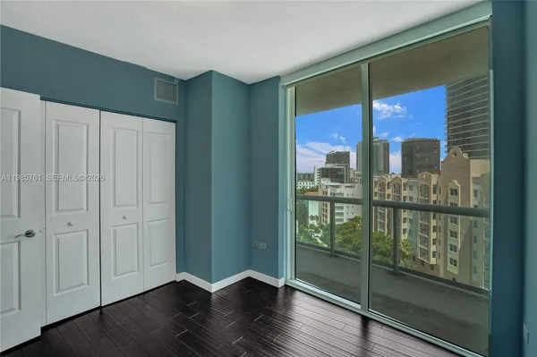 a view of a livingroom with wooden floor and a window