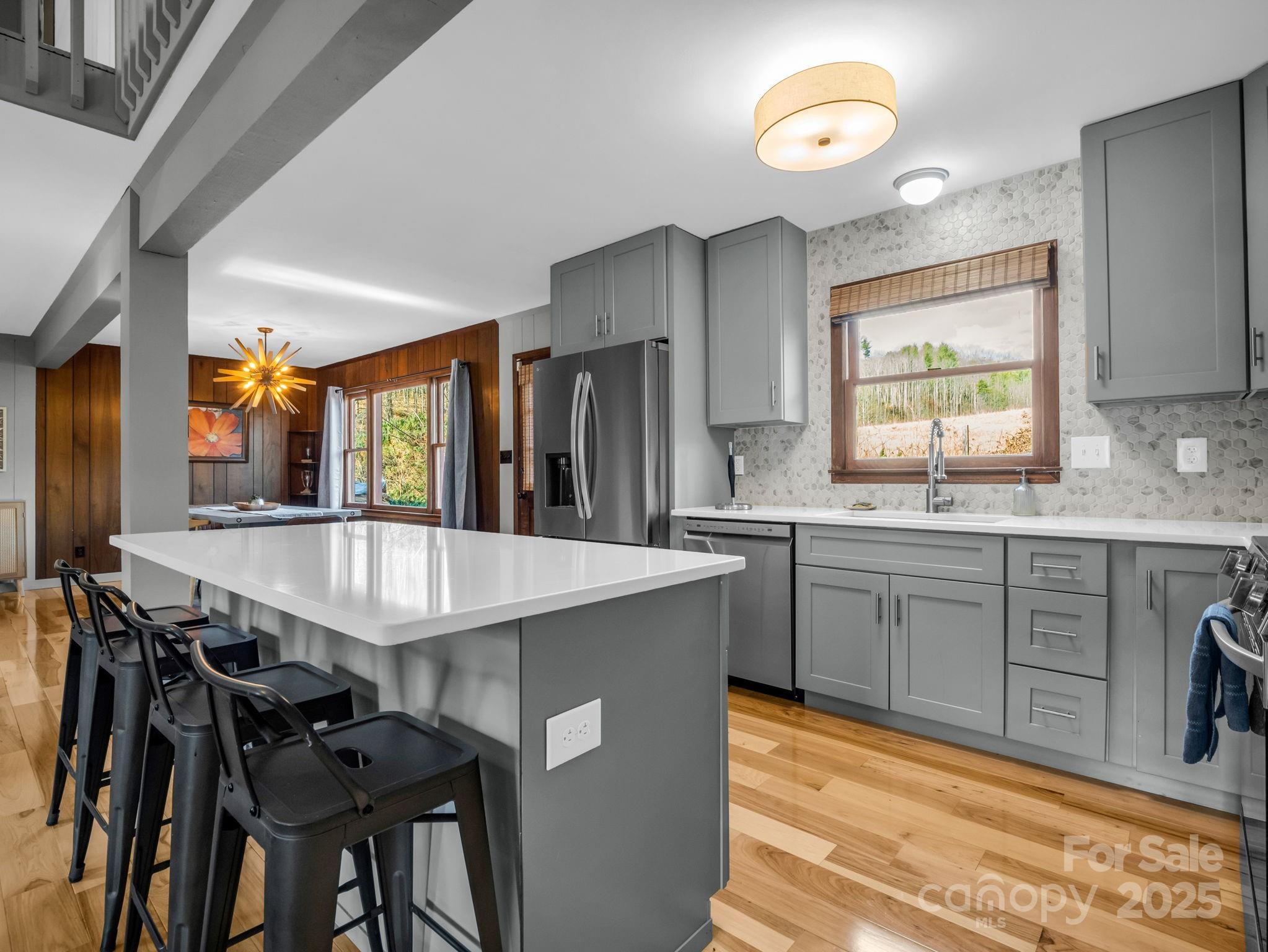 132 Hurd Road Canton, NC 28716 - Photo 25 of 46 a kitchen with stainless steel appliances granite countertop table chairs sink and cabinets