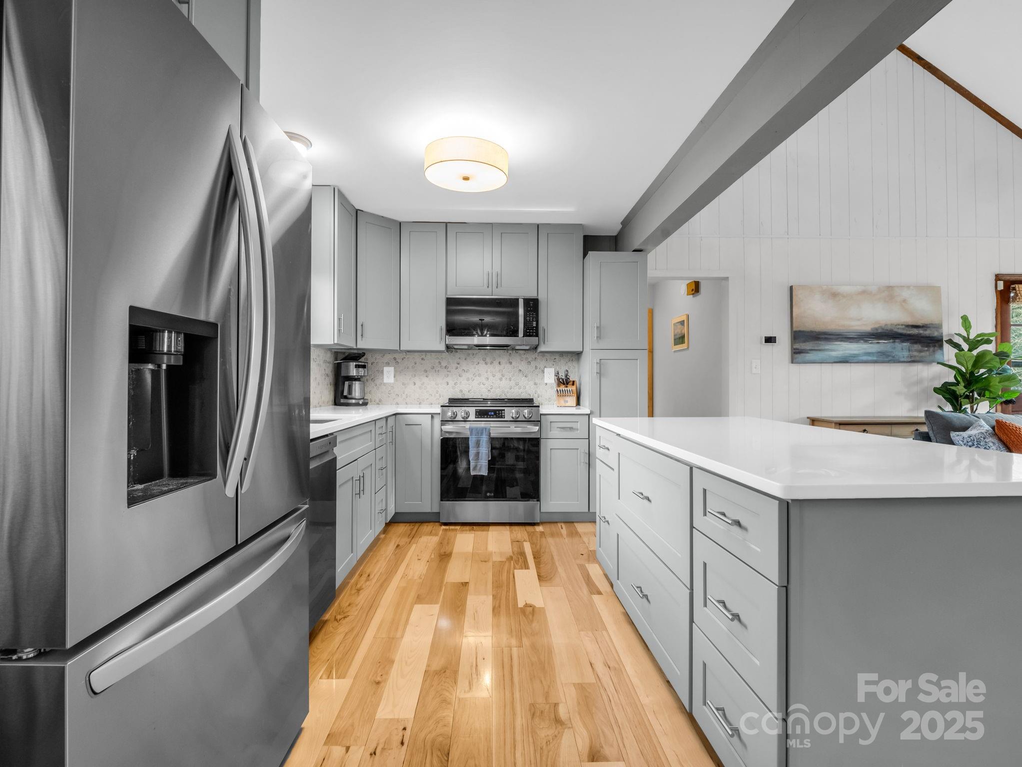 132 Hurd Road Canton, NC 28716 - Photo 26 of 46 a large kitchen with stainless steel appliances granite countertop a stove a sink and a refrigerator