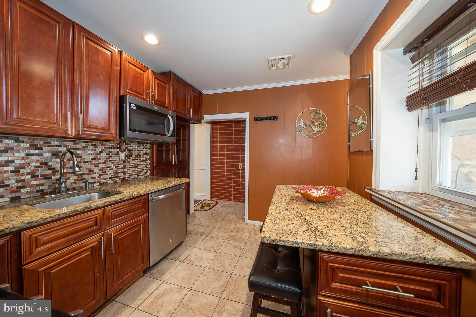 136 Summit Avenue Upper Darby, PA 19082 - Photo 13 of 48 a kitchen with granite countertop stainless steel appliances and wooden cabinets