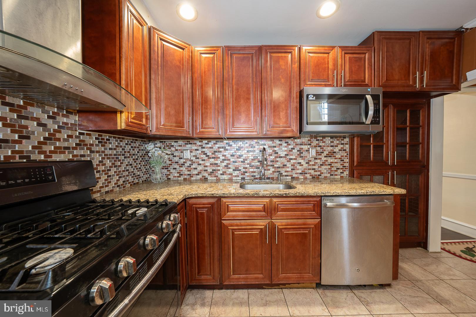 136 Summit Avenue Upper Darby, PA 19082 - Photo 14 of 48 a kitchen with granite countertop a stove and a sink