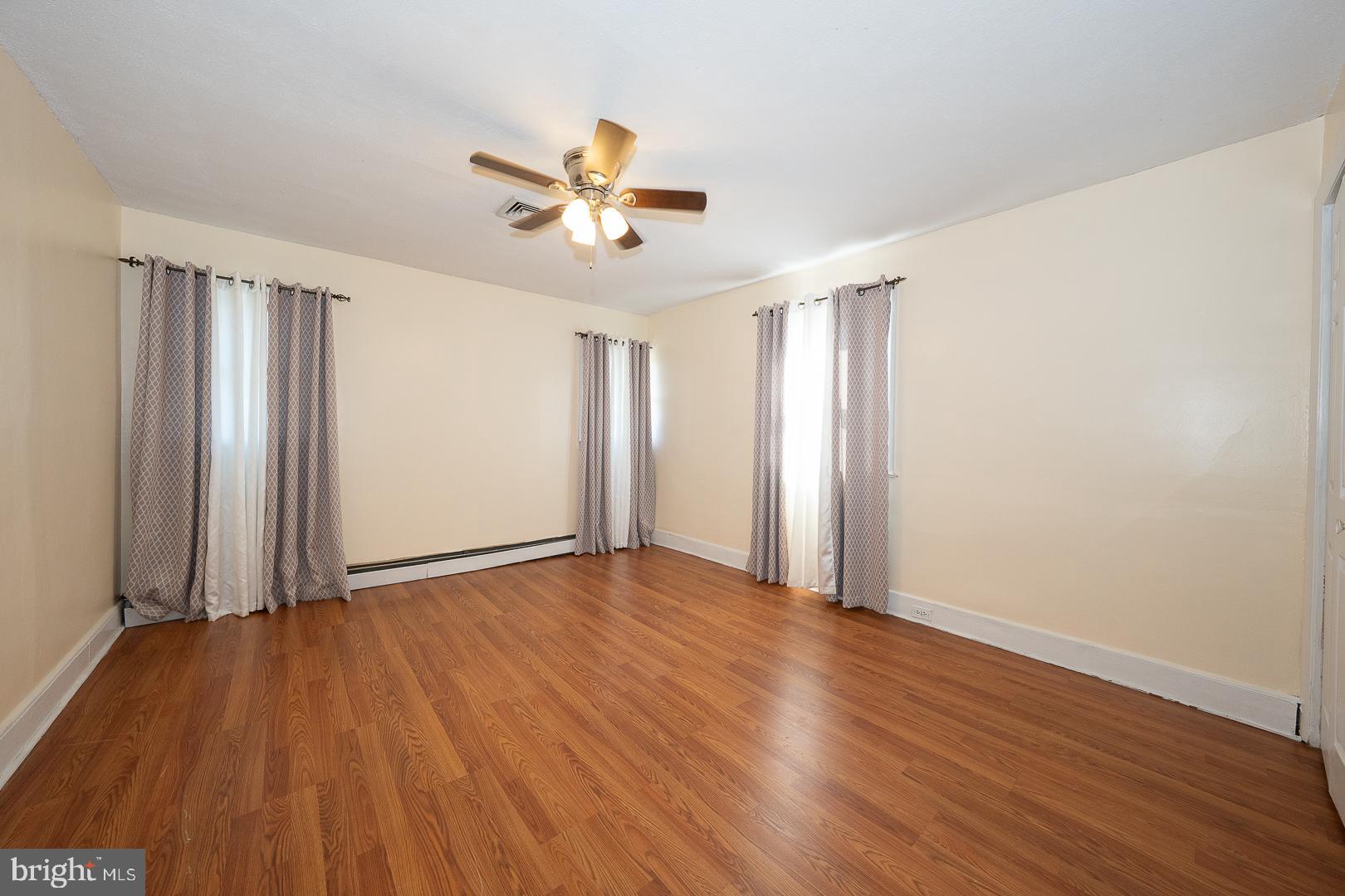 136 Summit Avenue Upper Darby, PA 19082 - Photo 17 of 48 an empty room with wooden floor closet and windows