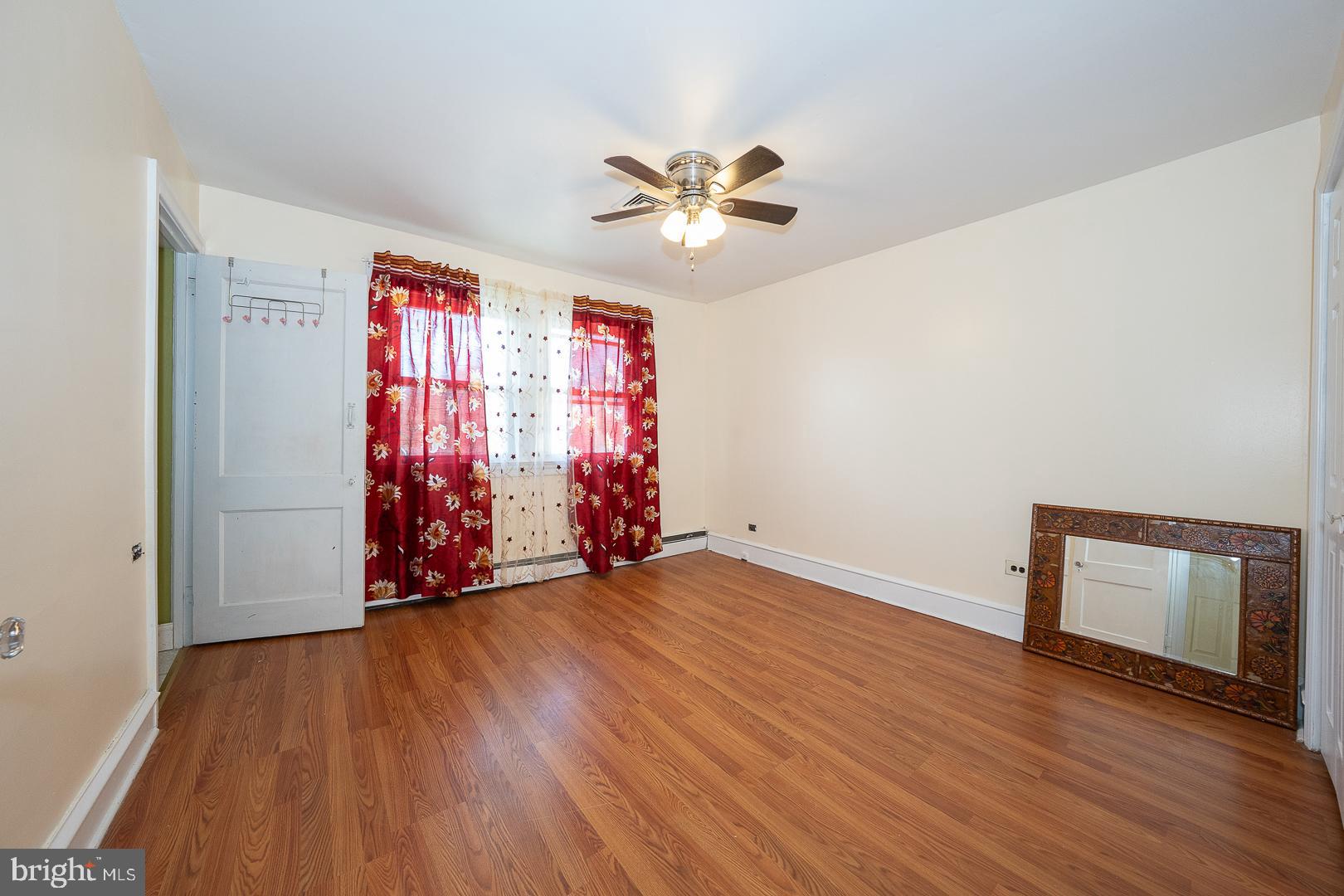 136 Summit Avenue Upper Darby, PA 19082 - Photo 21 of 48 an empty room with wooden floor closet fan and windows