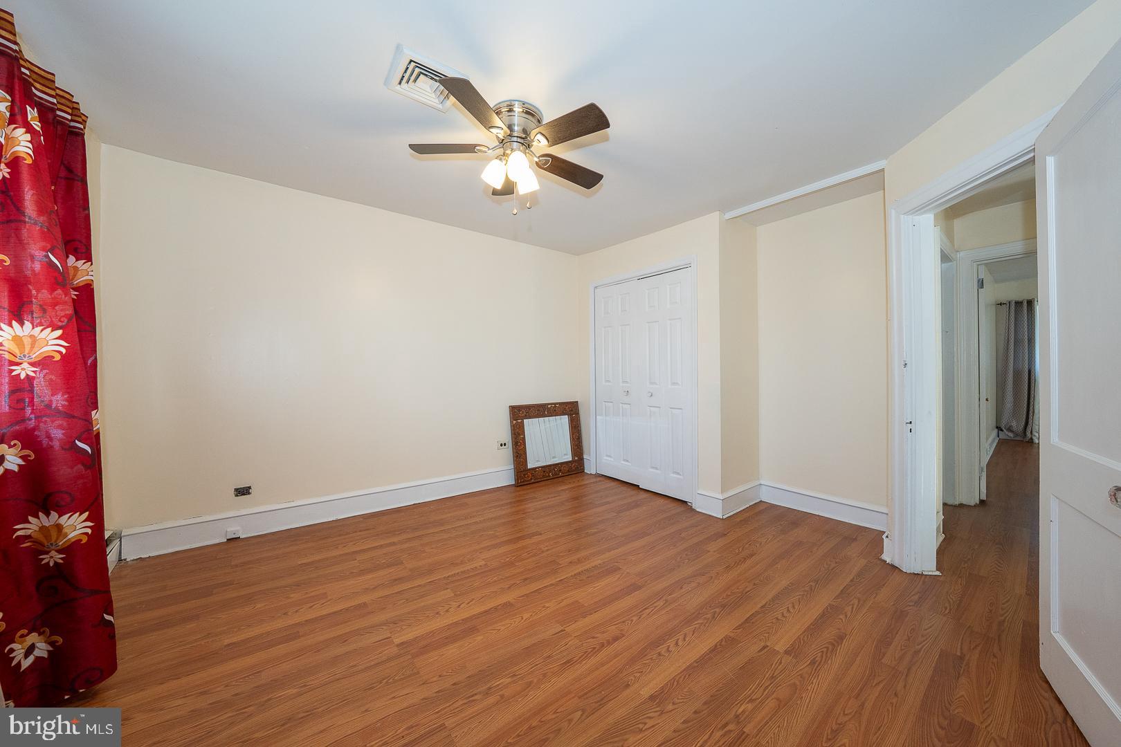 136 Summit Avenue Upper Darby, PA 19082 - Photo 22 of 48 a view of an empty room with wooden floor and a ceiling fan