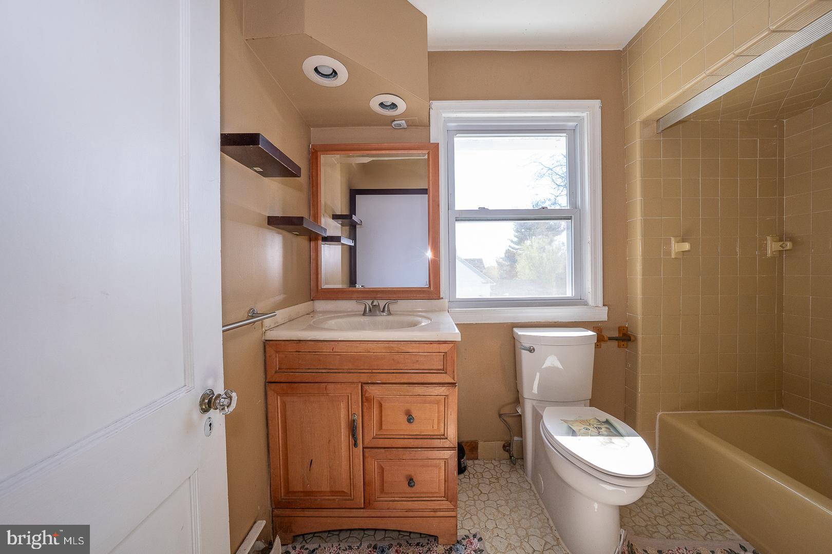 136 Summit Avenue Upper Darby, PA 19082 - Photo 24 of 48 a bathroom with a granite countertop toilet a sink and a window