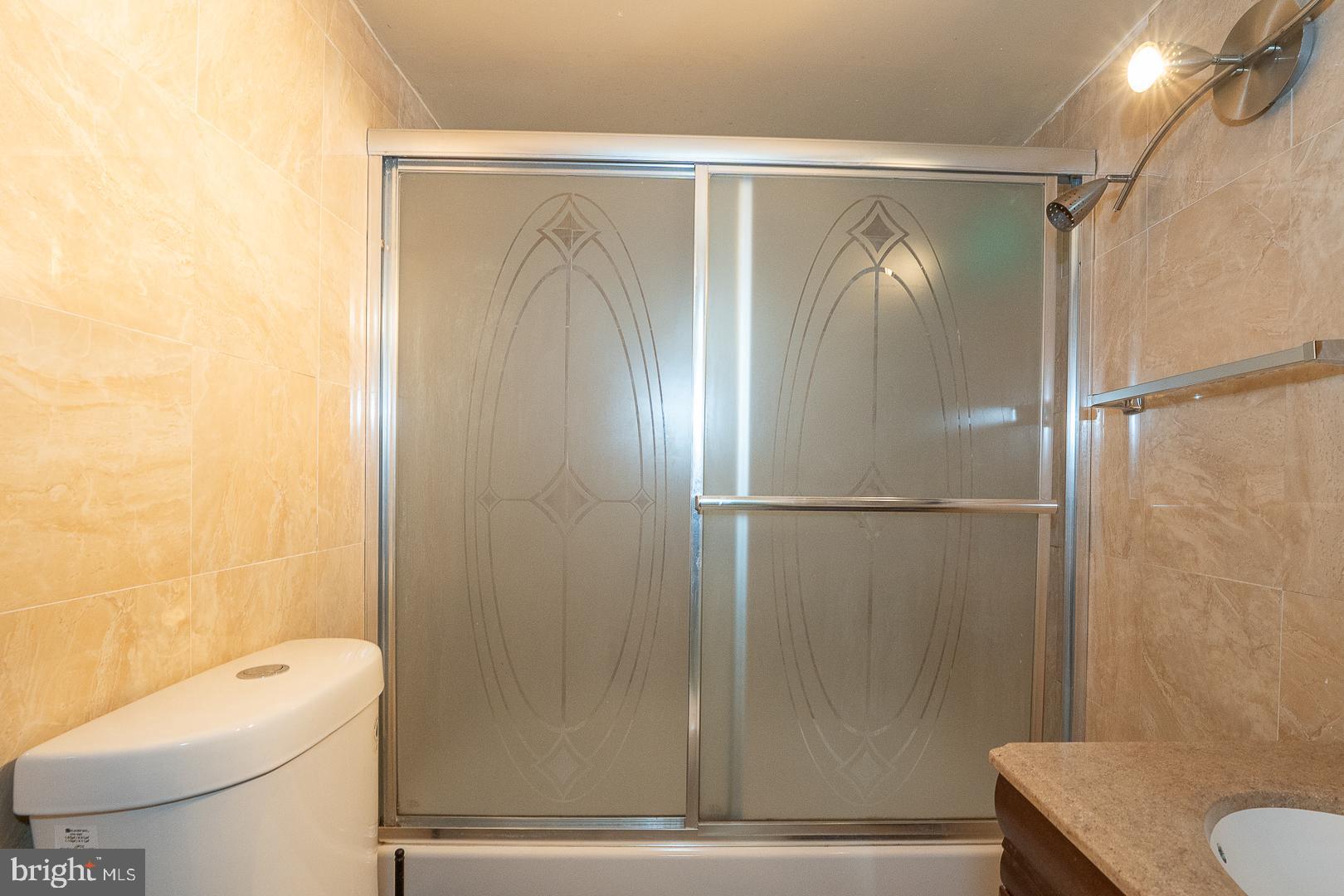 136 Summit Avenue Upper Darby, PA 19082 - Photo 35 of 48 a bathroom with a shower a toilet and a sink