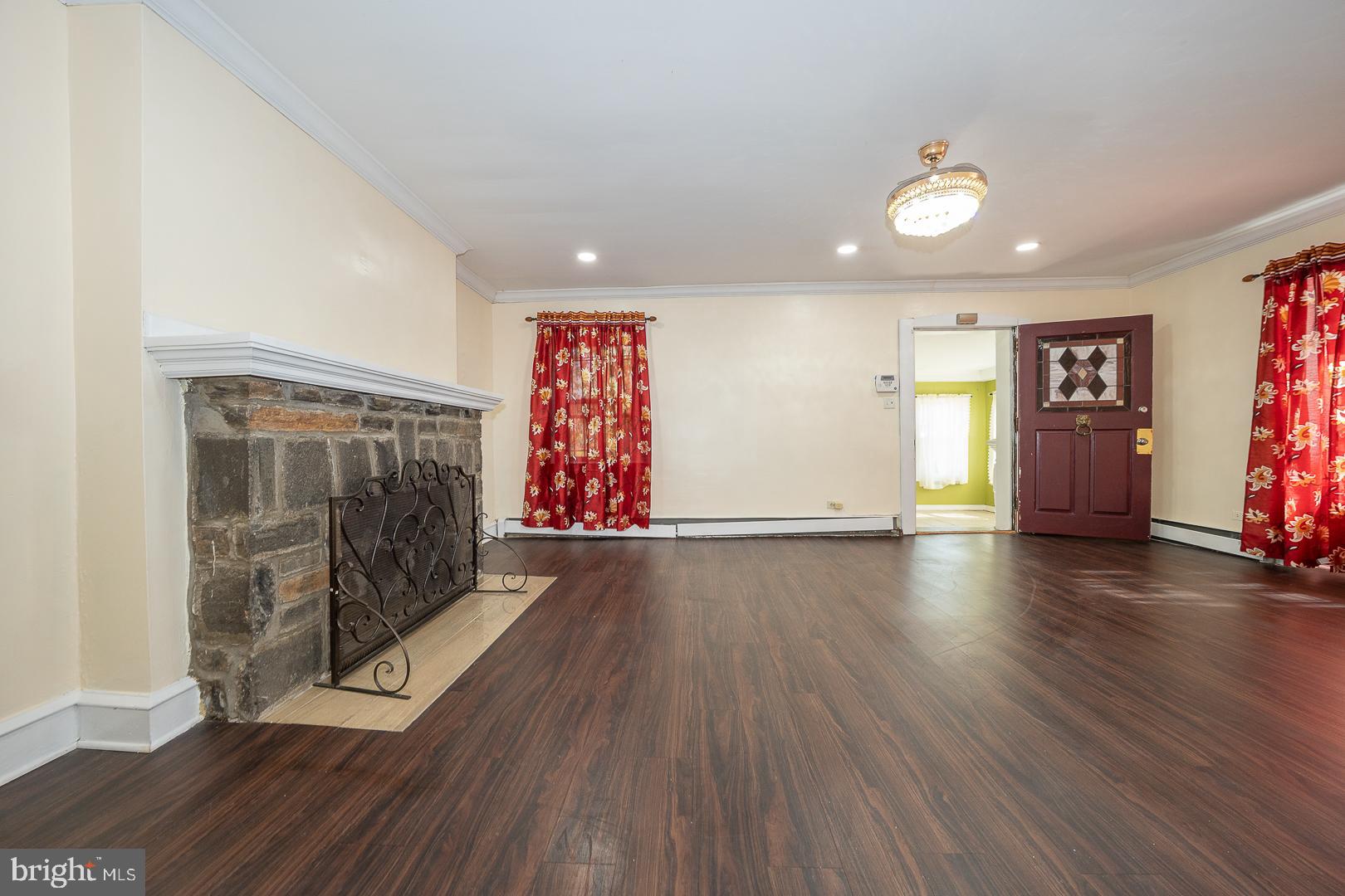 136 Summit Avenue Upper Darby, PA 19082 - Photo 9 of 48 an empty room with wooden floor and windows