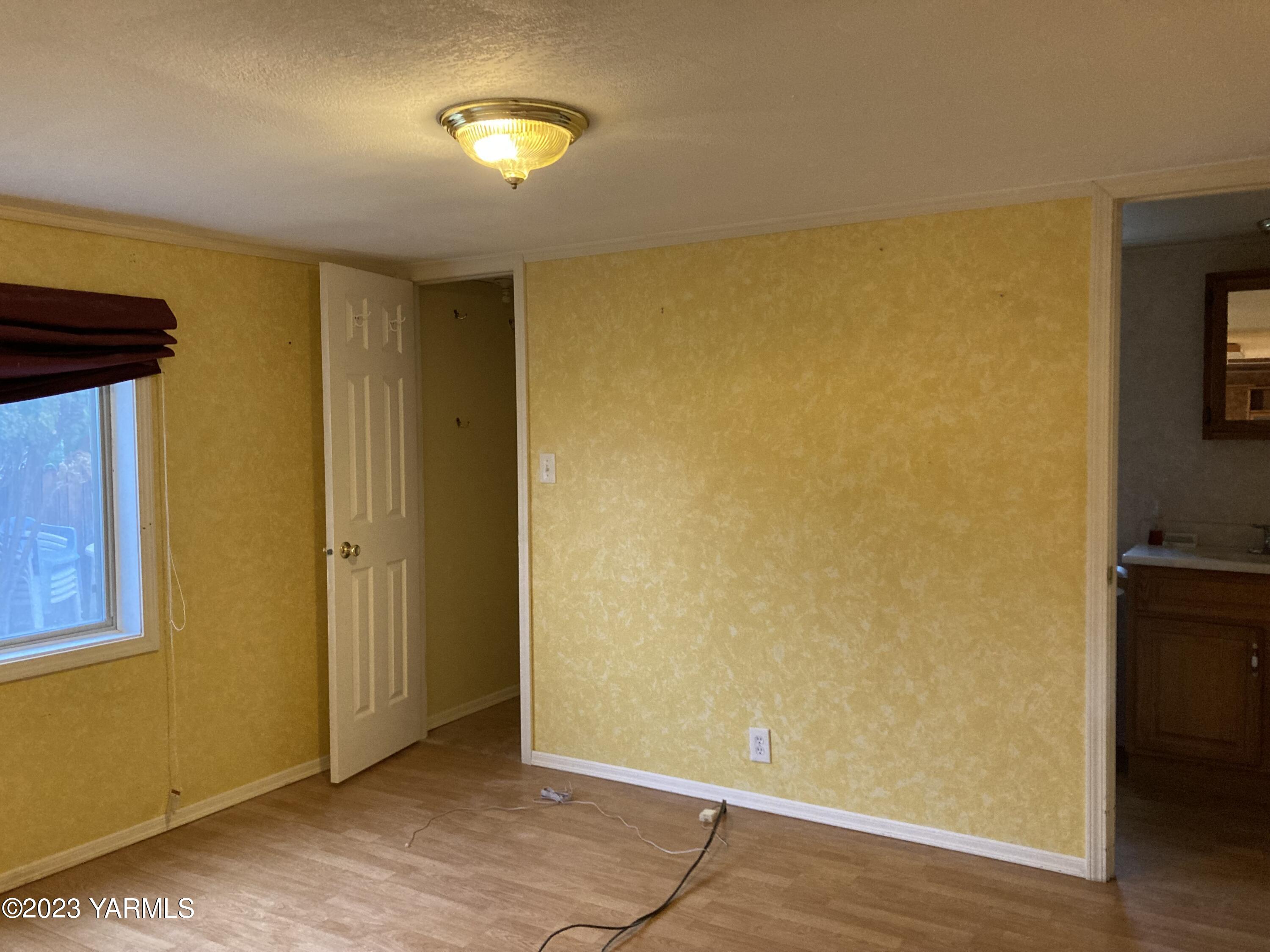 300 Alps Road, Unit 1042 Moxee, WA 98936 - Photo 6 of 15 a view of a room with a wooden floor and a window