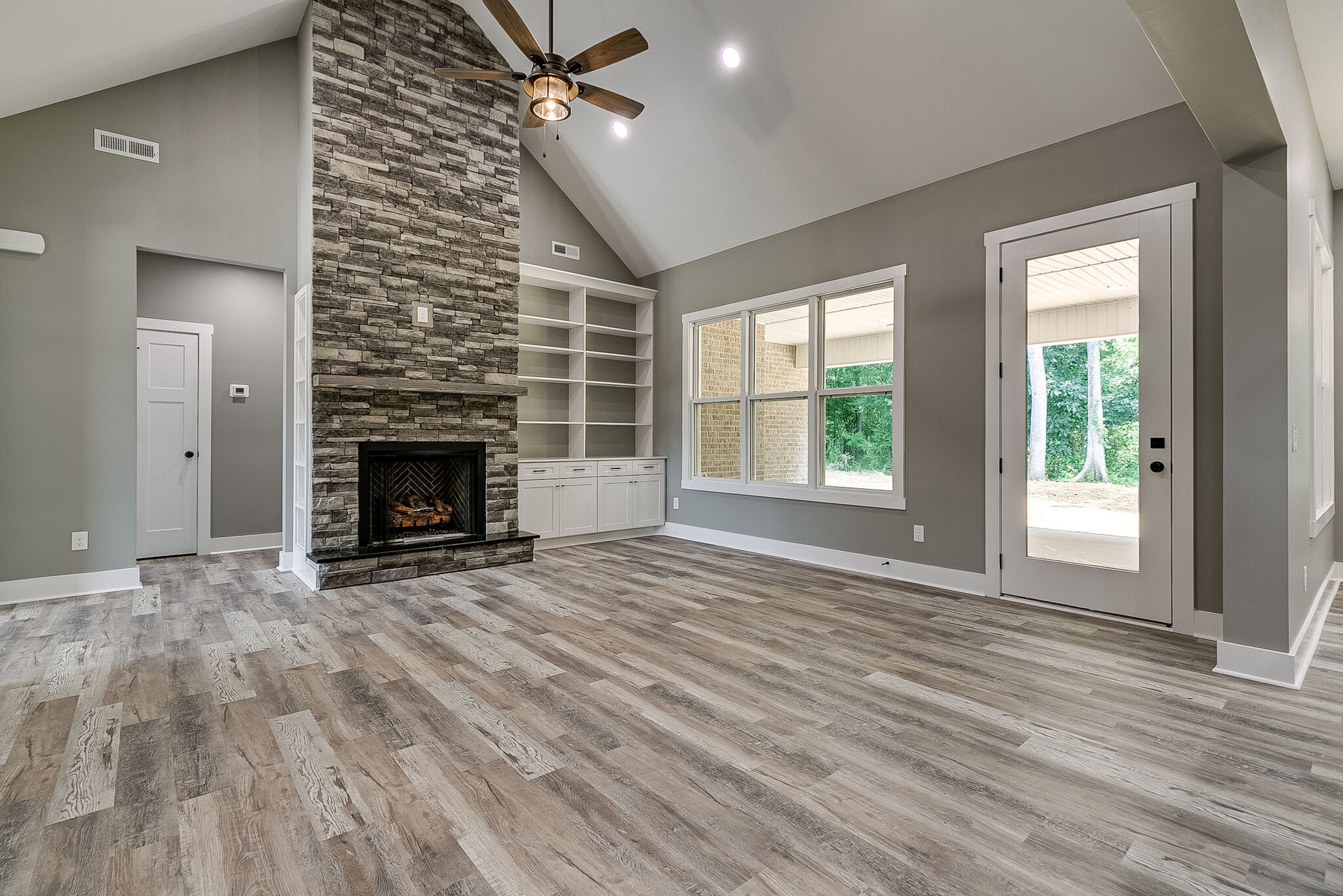 85 Post Road Manchester, TN 37355 - Photo 12 of 48 an empty room with windows fireplace and wooden floor