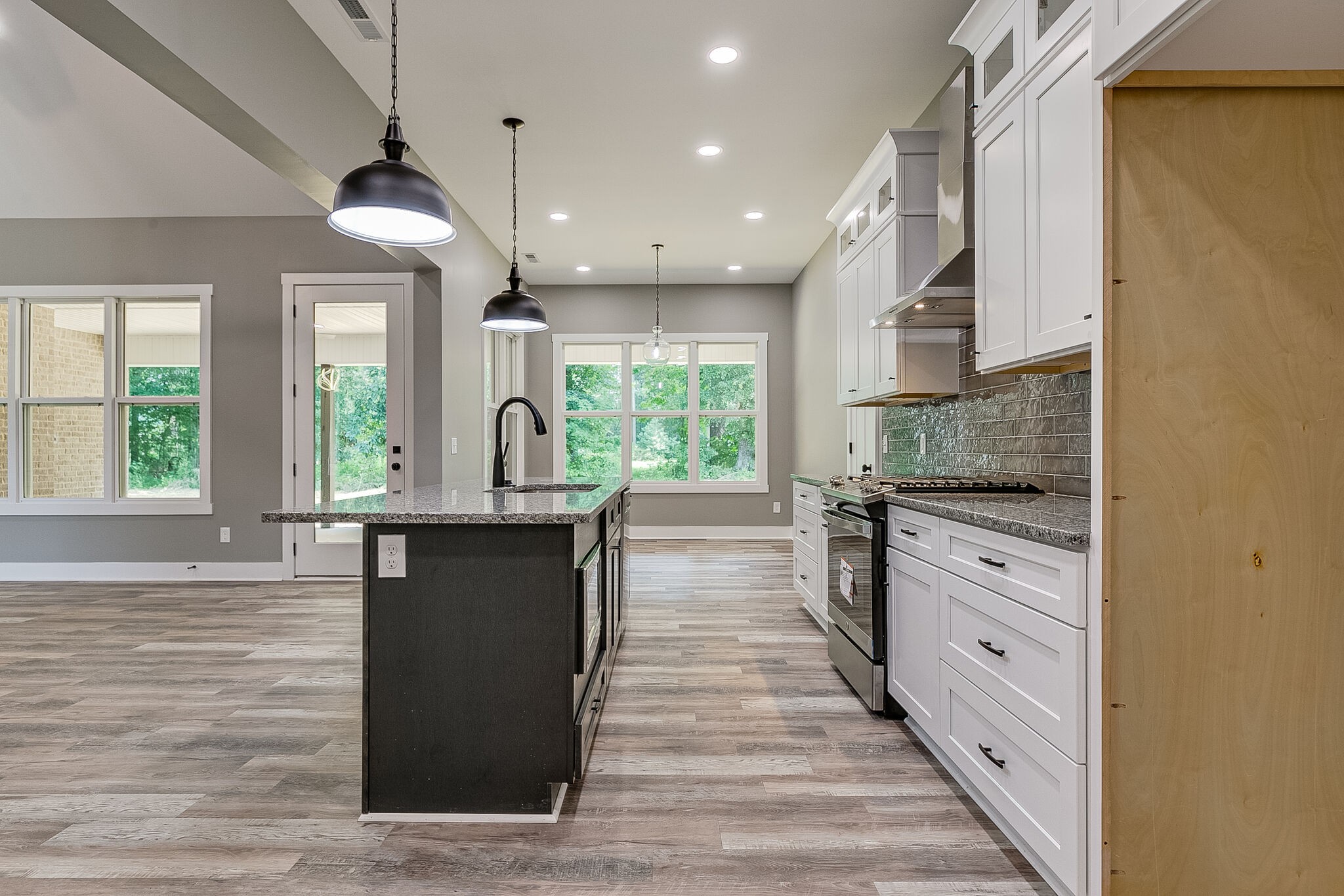 85 Post Road Manchester, TN 37355 - Photo 14 of 48 a kitchen with kitchen island granite countertop a stove a sink and a refrigerator
