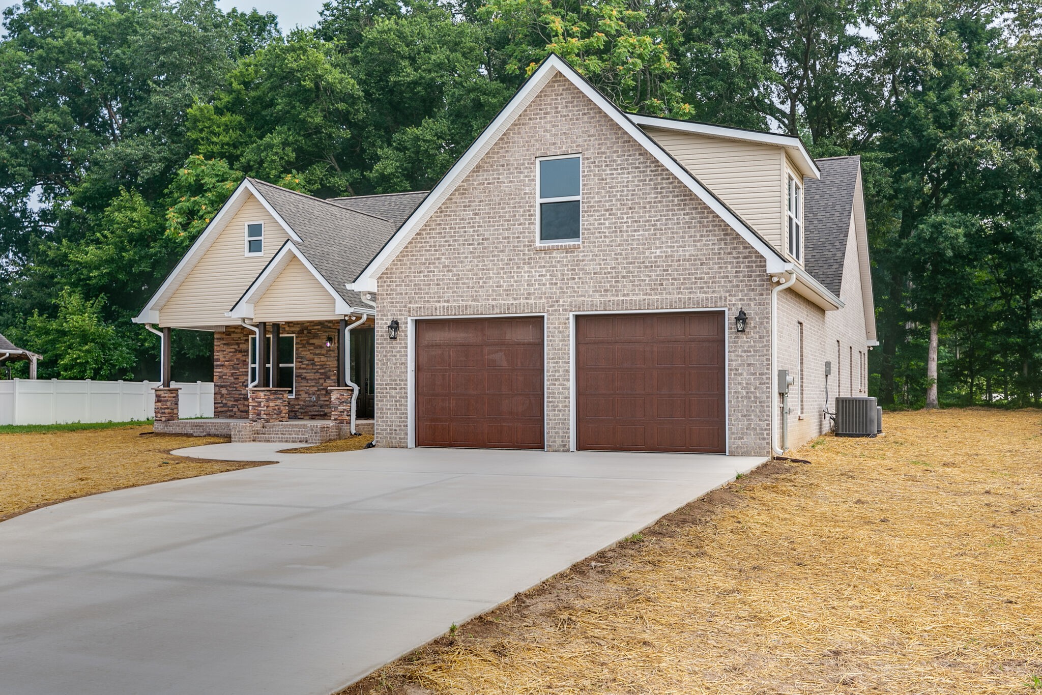 85 Post Road Manchester, TN 37355 - Photo 2 of 48 a front view of a house with yard and trees in the background