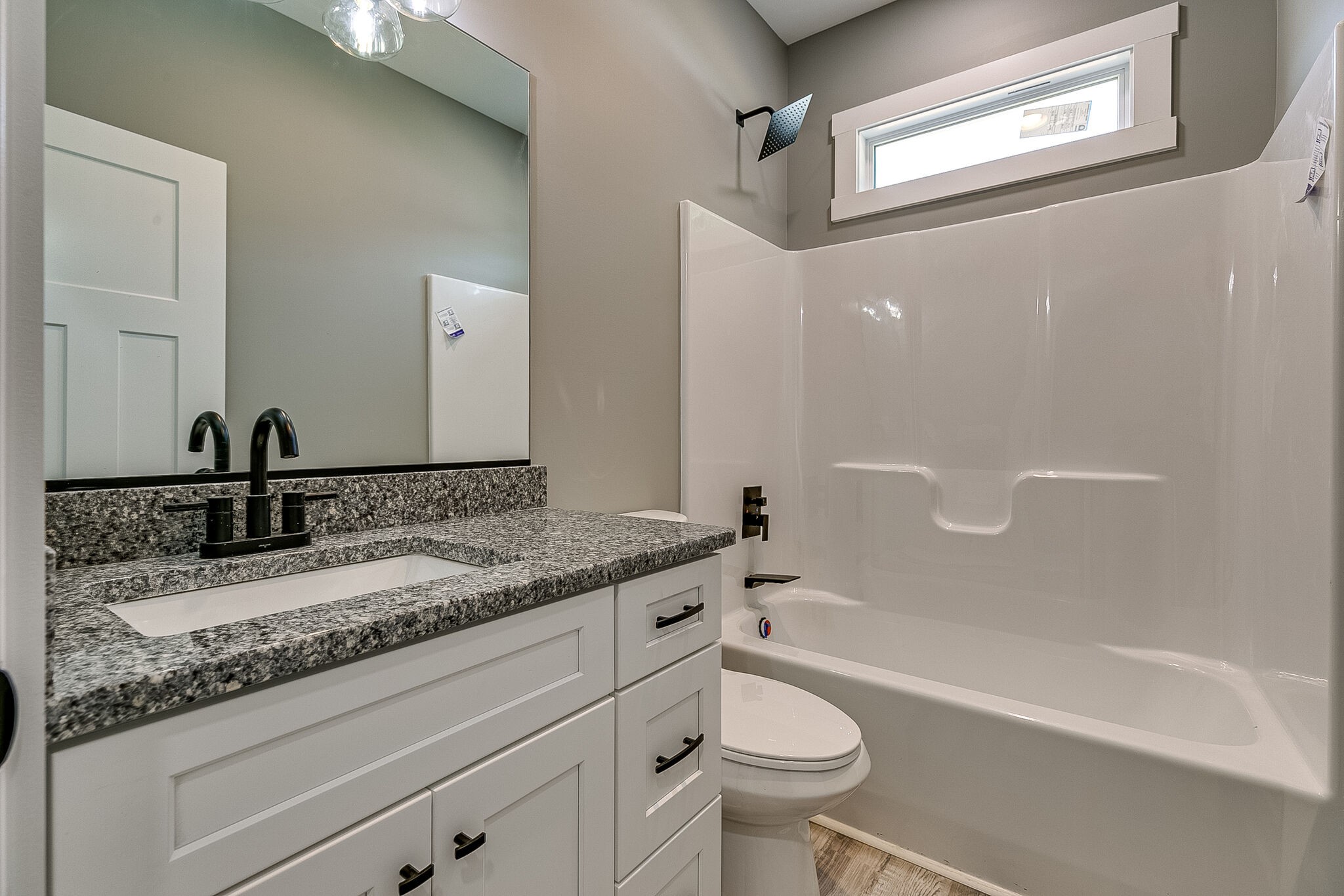 85 Post Road Manchester, TN 37355 - Photo 26 of 48 a bathroom with a granite countertop sink a toilet and bathtub