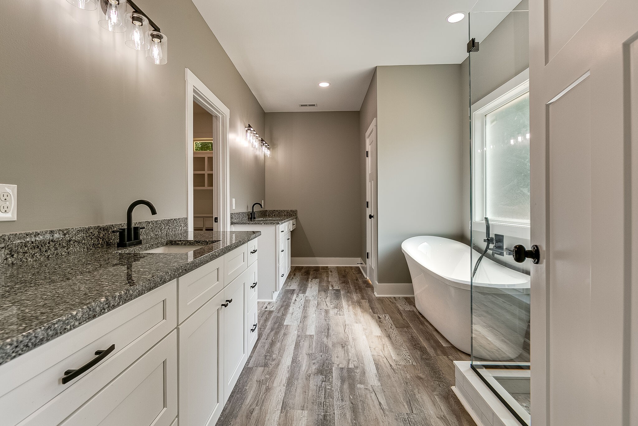 85 Post Road Manchester, TN 37355 - Photo 36 of 48 a spacious bathroom with a double vanity sink a mirror and a bathtub