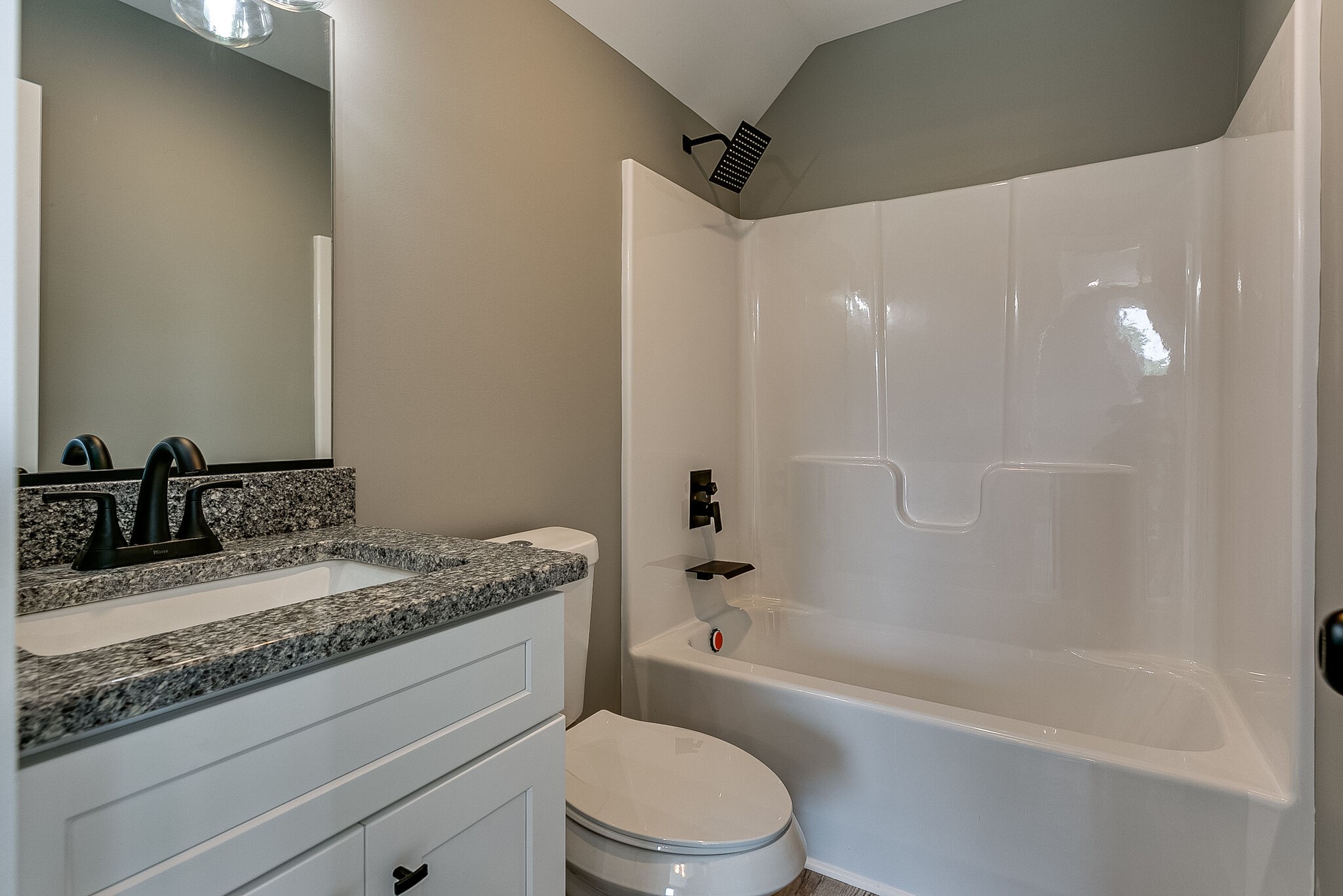 85 Post Road Manchester, TN 37355 - Photo 42 of 48 a bathroom with a granite countertop sink a toilet and bathtub