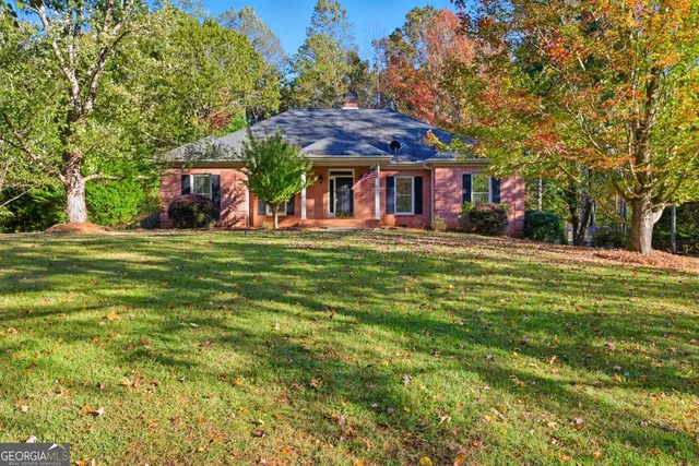 a front view of a building with a garden