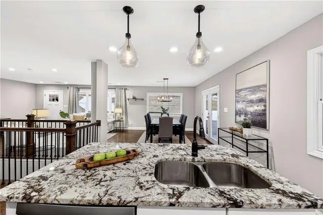 a kitchen with stainless steel appliances a refrigerator sink and microwave