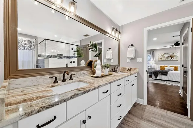 a bathroom with a double vanity sink and shower