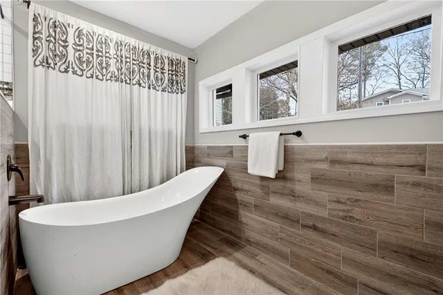 a view of a big room with wooden floor closet and windows