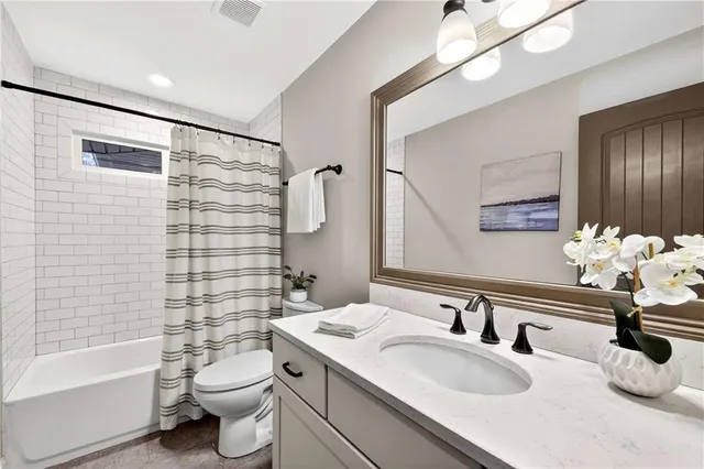 a view of an empty room with wooden floor and closet