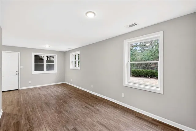 a view of an empty room with wooden floor