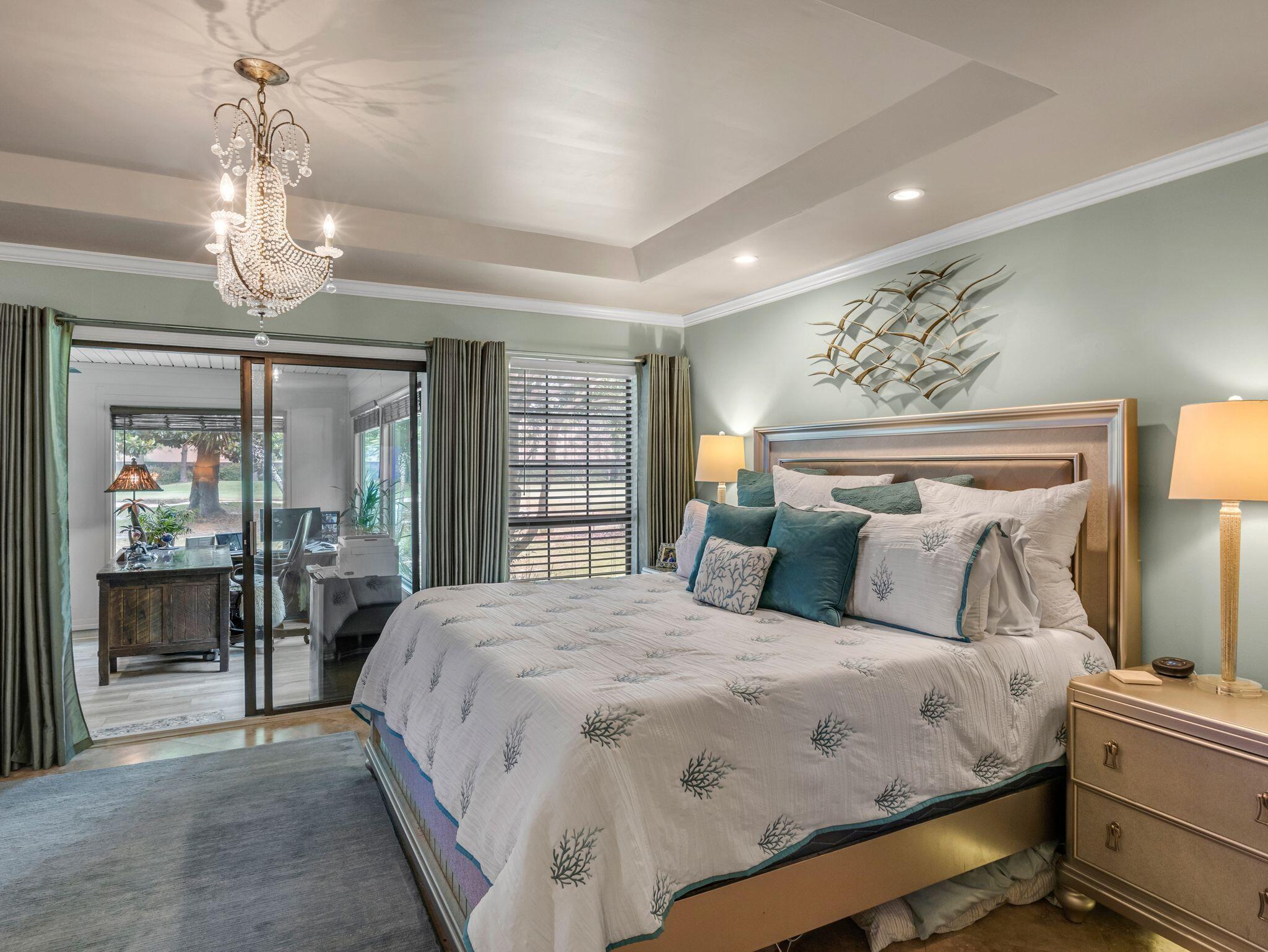 370 Golfview Drive Miramar Beach, FL 32550 - Photo 29 of 148 a bedroom with a large bed and a chandelier