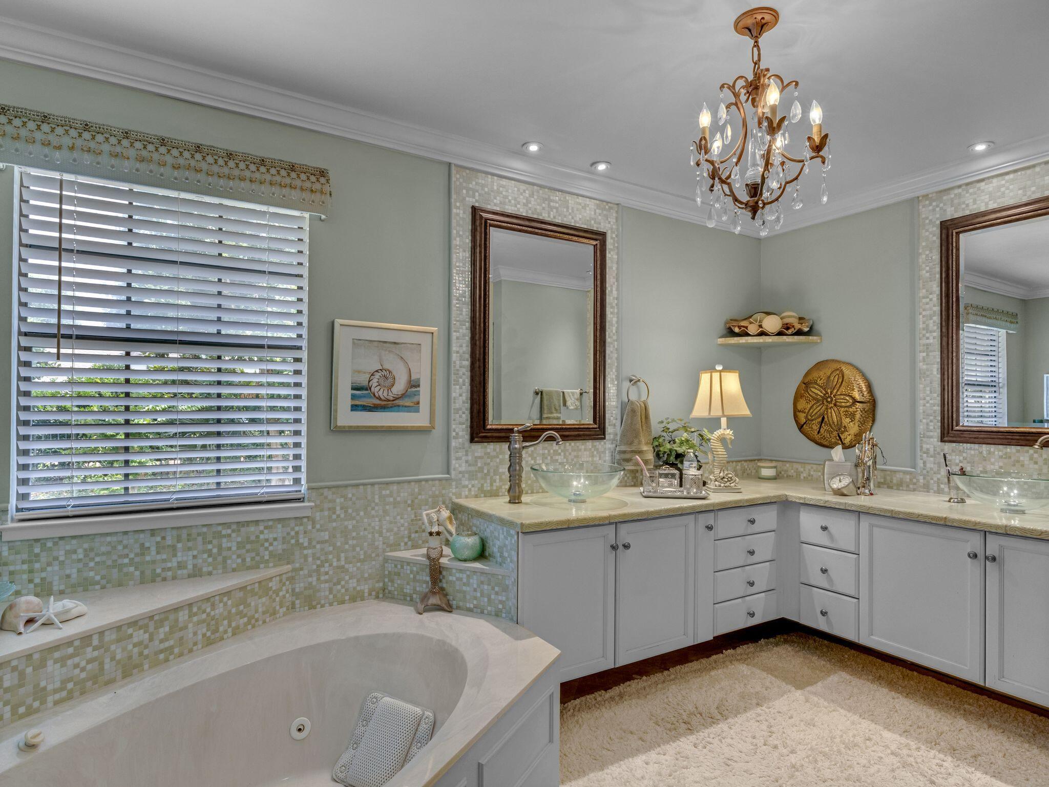 370 Golfview Drive Miramar Beach, FL 32550 - Photo 30 of 148 a bathroom with a sink a large mirror a bathtub and a window