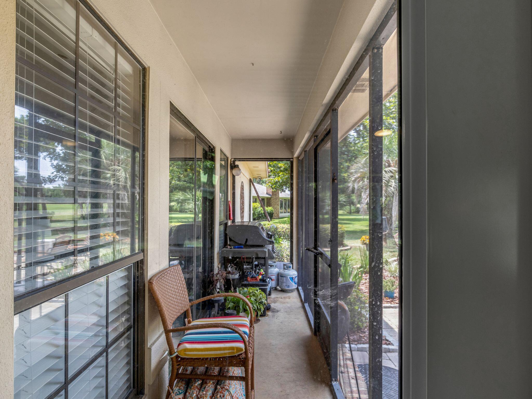 370 Golfview Drive Miramar Beach, FL 32550 - Photo 44 of 148 a living room with furniture and a floor to ceiling window