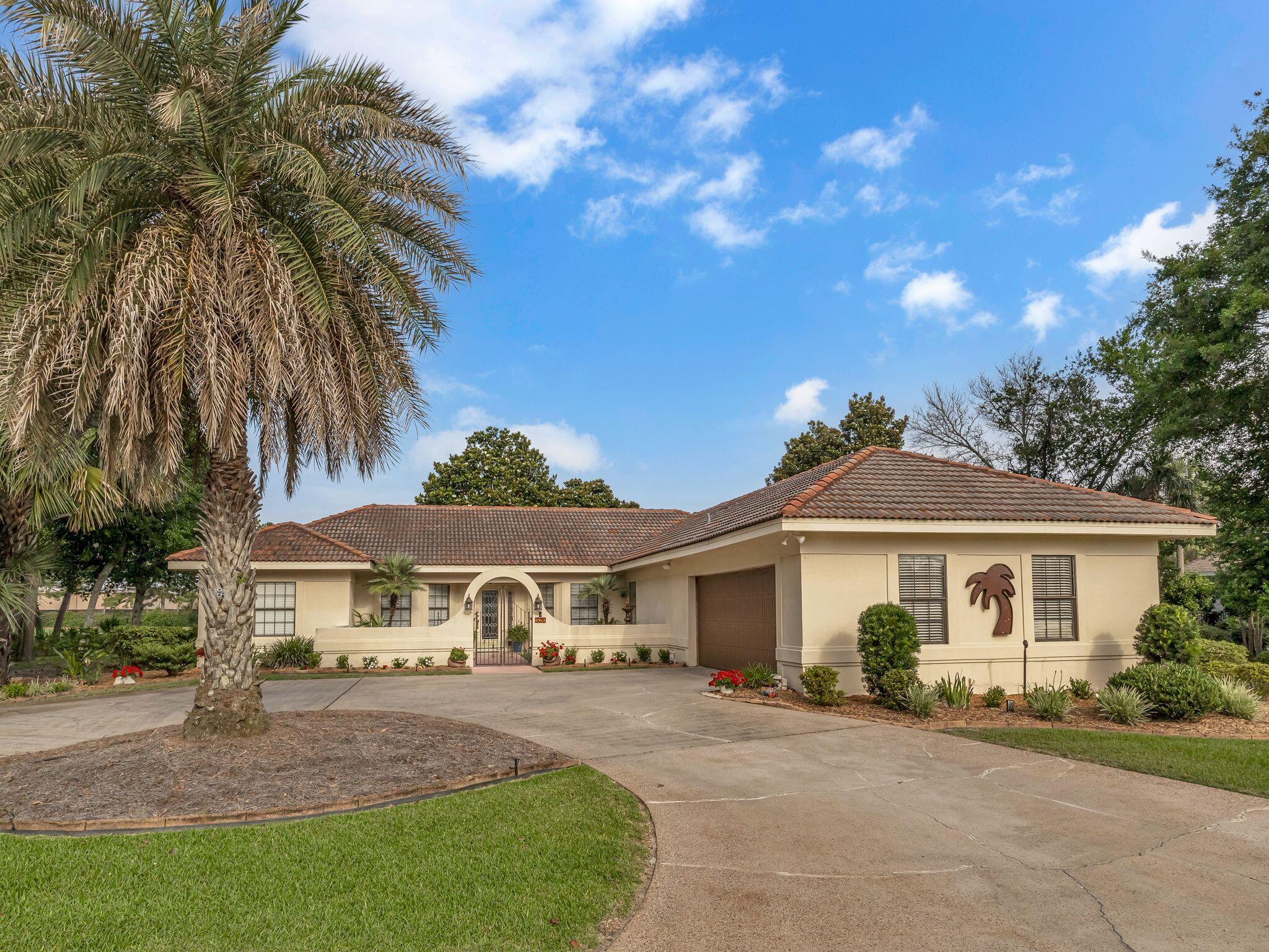 370 Golfview Drive Miramar Beach, FL 32550 - Photo 55 of 148 a front view of a house with a garden
