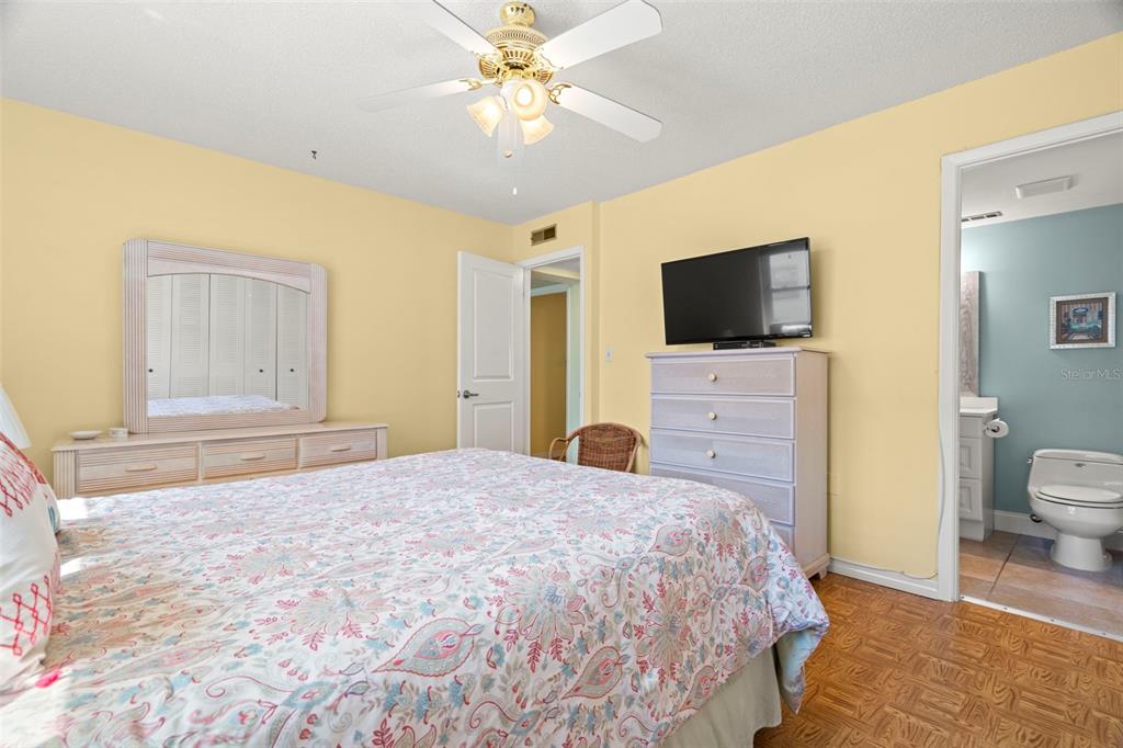 7701 Starkey Road, Unit 601 Seminole, FL 33777 - Photo 14 of 28 a spacious bedroom with a bed and a flat screen tv