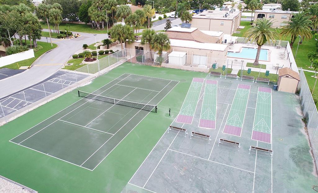 7701 Starkey Road, Unit 601 Seminole, FL 33777 - Photo 25 of 28 a view of a tennis ground with large trees