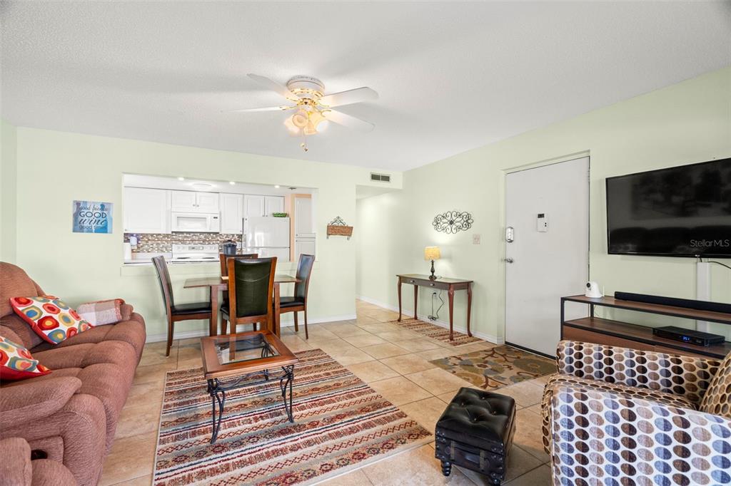 7701 Starkey Road, Unit 601 Seminole, FL 33777 - Photo 6 of 28 a living room with furniture and a flat screen tv