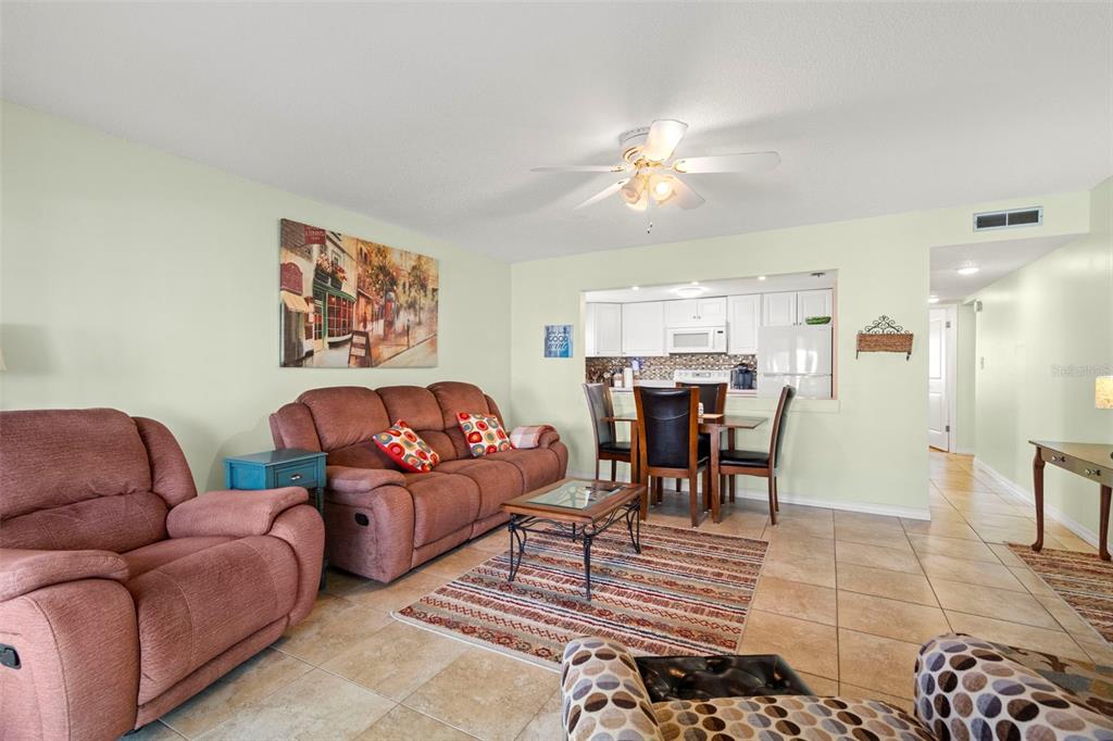 7701 Starkey Road, Unit 601 Seminole, FL 33777 - Photo 7 of 28 a living room with furniture and kitchen view