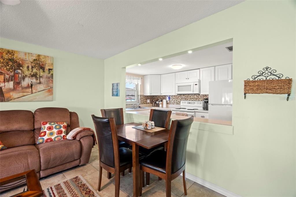 7701 Starkey Road, Unit 601 Seminole, FL 33777 - Photo 8 of 28 a living room with stainless steel appliances kitchen island granite countertop furniture and a wooden floor