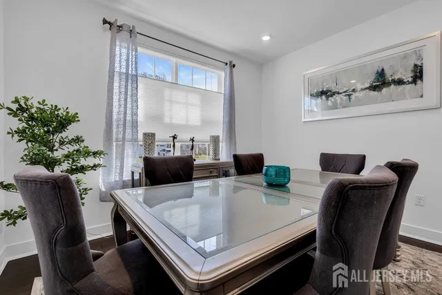 a dining room with furniture and wooden floor