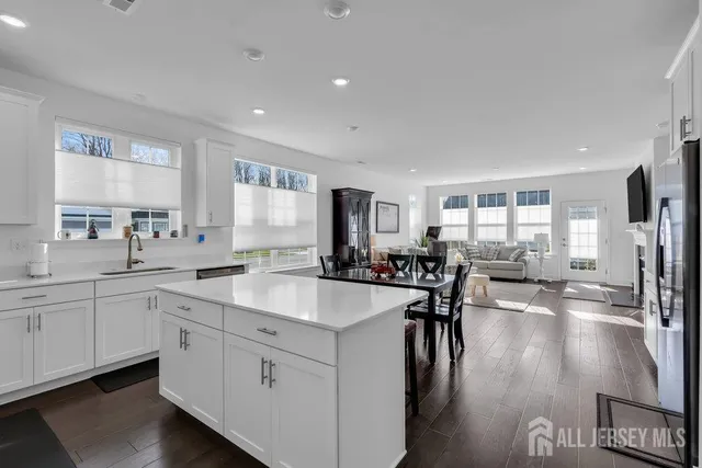 a large white kitchen with lots of counter space and a sink