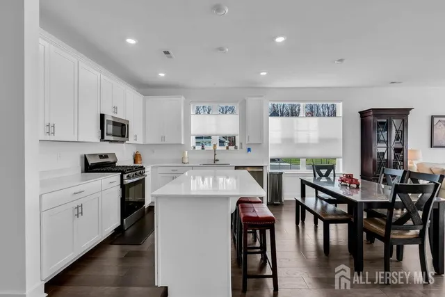 a kitchen with cabinets table and chairs
