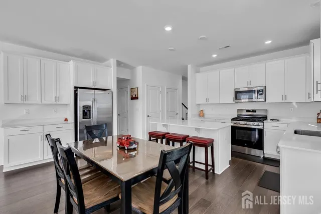 a kitchen that has a table and chairs in it