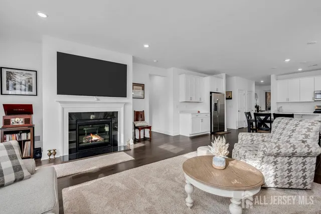 a living room with furniture a fireplace and a flat screen tv