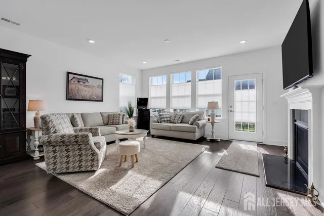 a living room with furniture fireplace and a flat screen tv