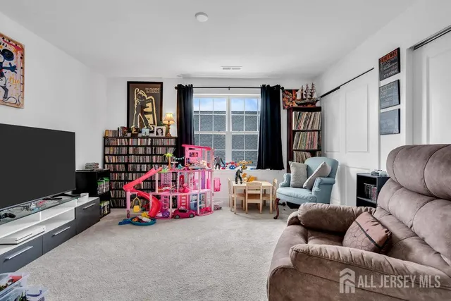 a bedroom with furniture and a flat screen tv