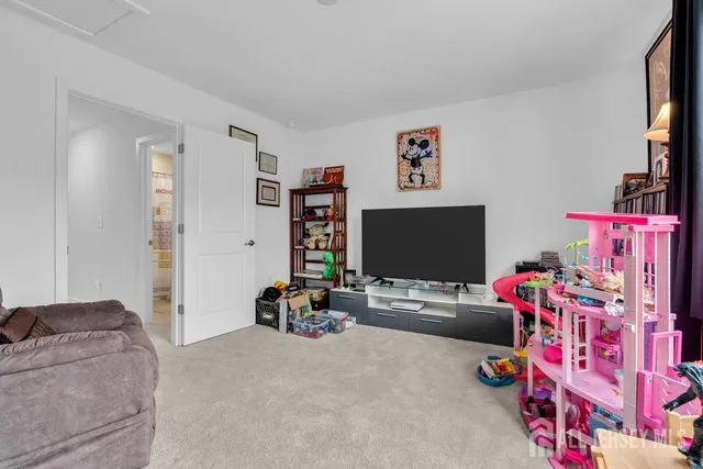 a bedroom with furniture and a flat screen tv