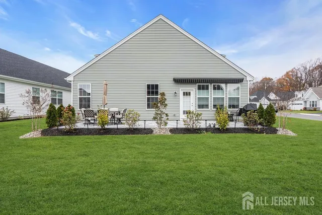 a front view of house with yard barbeque and outdoor seating
